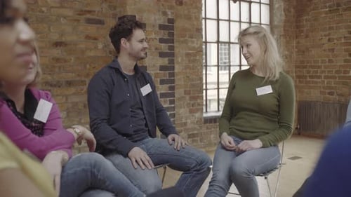 Couple making up and talking during group therapy session