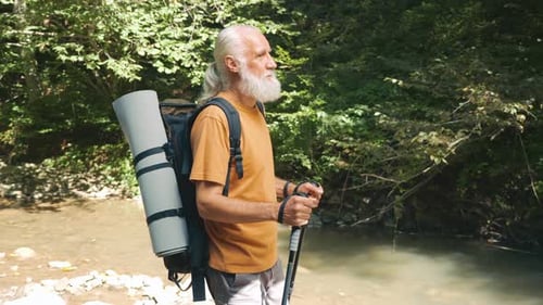 Senior Man Hiking Near Forest River