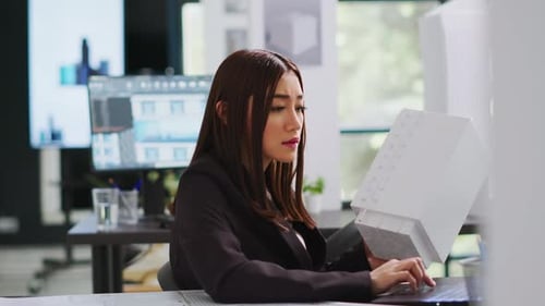 Developer Analyzing 3d Building Model at Realty Office