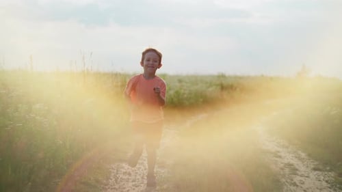 Slow Motion Video of a Boy Running Along a Country Road