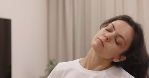 Woman Performing Neck Stretches for Health and Wellness