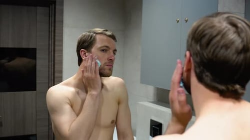 Man Applying Shaving Cream in Modern Bathroom