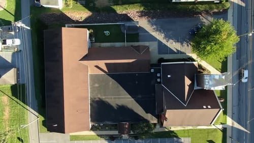 Overhead aerial birds eye view of church building. New and old sections, steeple and community town
