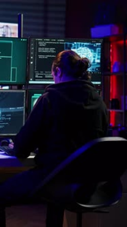 Programmer Works at Computer with Multiple Monitors