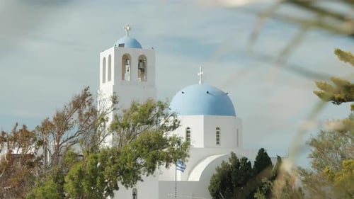 Church with blue dome and bell tower in Santorini, Greece