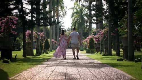 Romantic Couple Strolling Through a Tropical Garden Paradise