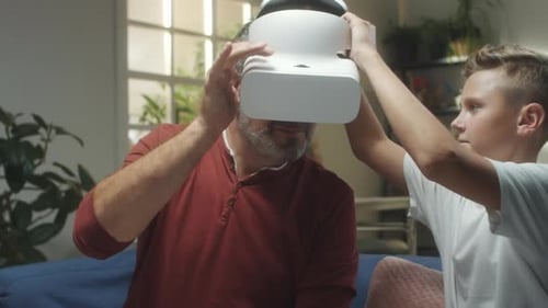 Dad Enjoys VR Headset with Teen Son