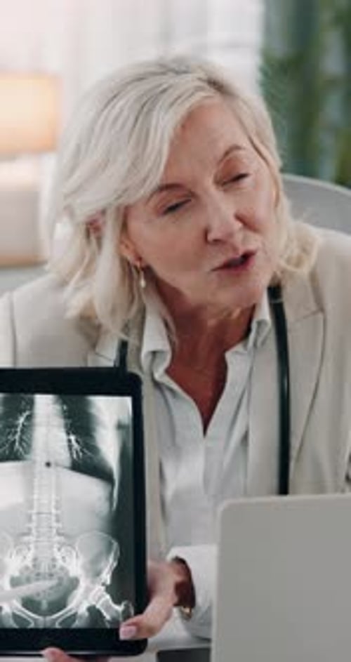 Mature, doctor and tablet screen with xray in office for check up results