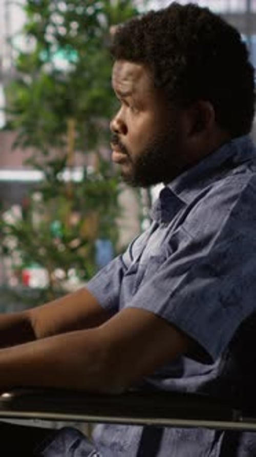 Adult Man in Wheelchair Sits Near Office