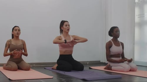 Women Doing Yoga and Stretching Indoors