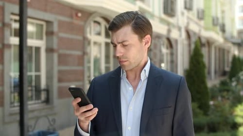 Close Up Confident Businessman Typing Messages on Phone at City Street. Successful