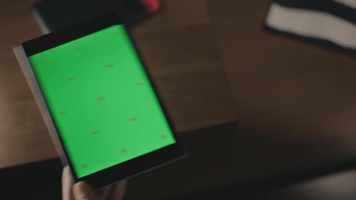 Female Hand Touching Green Screen Tablet Computer. Close Up Female Finger Tapping
