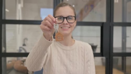 Real Estate Agent Offering Home Keys