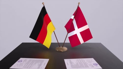 German and Danish Flags Stand on Table