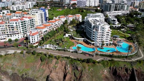slow moving shot of a family hotel complex on the corner of an idyllic part of the madeiran coast li