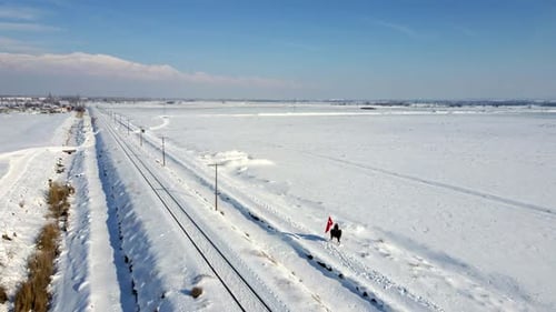 Lone Horse Rider Exploring Snowy Winter Landscape