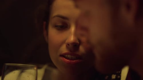 Happy young woman smiling in dimly lit room