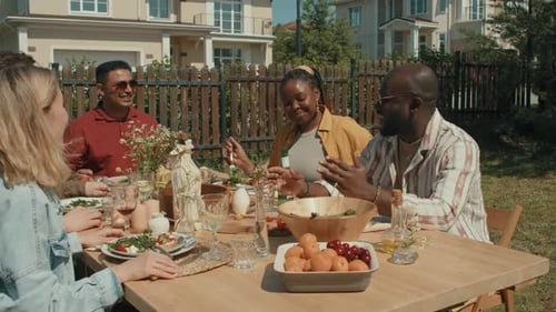 Friends Enjoy Lunch Together at Backyard Gathering