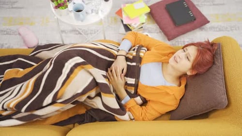Woman Lying on Couch with Stomach Pain