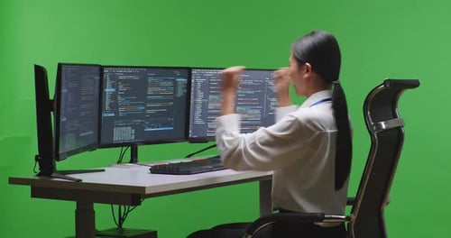 Happy Asian Woman Developer Celebrating While Write Code With Multiple Screens In Green Screen