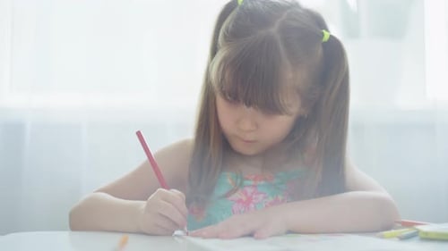 Girl Drawing at Table with Colored Pencil