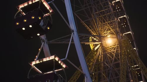 Bright Ferris Wheel Turning Spinning at Night at a Amusement Park
