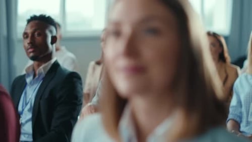 Conference Attendees Clapping at Business Meeting Presentation