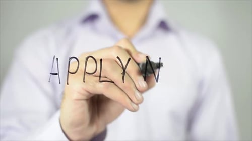 Hand Writes Apply Now With a Marker