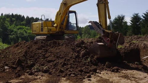 Excavator Digging Into Ground on a Construction Site