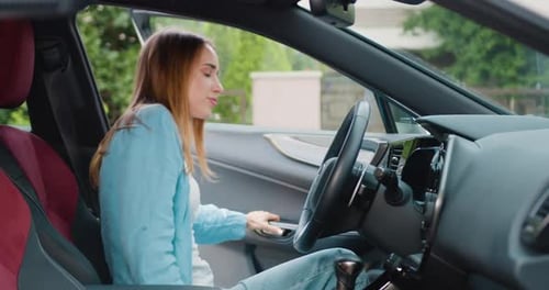 Woman Gets in Car and Buckles Seatbelt