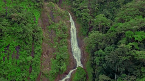 Drone shot of waterfall deep in jungle of Costa Rica