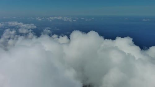 Flying Through White Clouds Over Sea