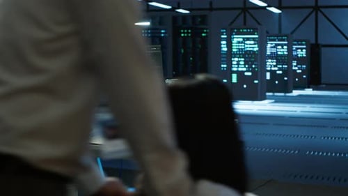 Woman in Wheelchair Doing Maintenance on Server Room Infrastructure