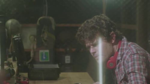 Audio Engineer Records in His Studio, Instruct the Guitarist to Play by the Beat and smiles while no