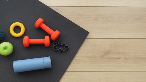 Fitness Equipment and Apple on Yoga Mat