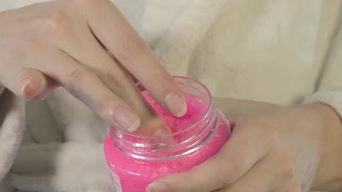 Woman Uses Bright Pink Sugar Scrub at Home