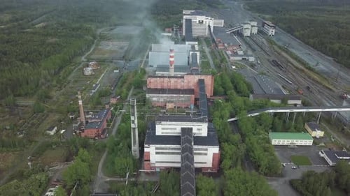 Industrial Plant Emitting Smoke in Natural Landscape