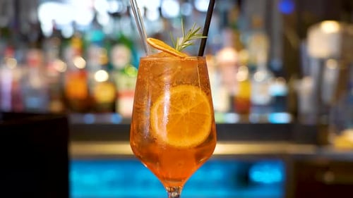 A cocktail on a bar. Colorful beautifully decorated drink in a bar.