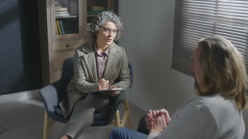 Adults Talking in Office Setting with Note Taking