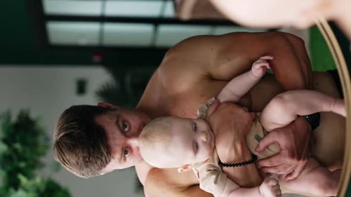 Father and Baby Look in Mirror