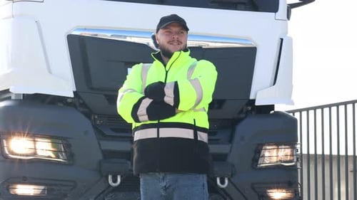 Happy young driver and modern truck parked outdoors