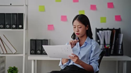Businesswoman is working on laptop in office space.