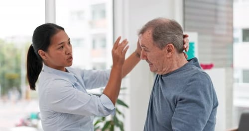 Senior Man Receives Physical Therapy at Clinic
