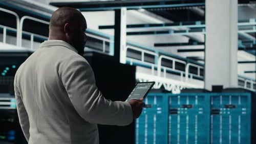 Data Center Technician Using Laptop to Manage Software Updates