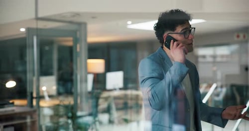 Young Professional on Mobile Phone in Modern Office