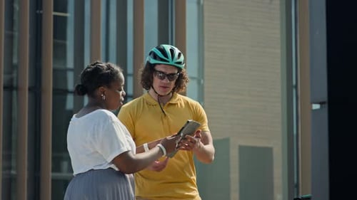Woman Putting E-signature on Tablet when Accepting Parcel from Courier