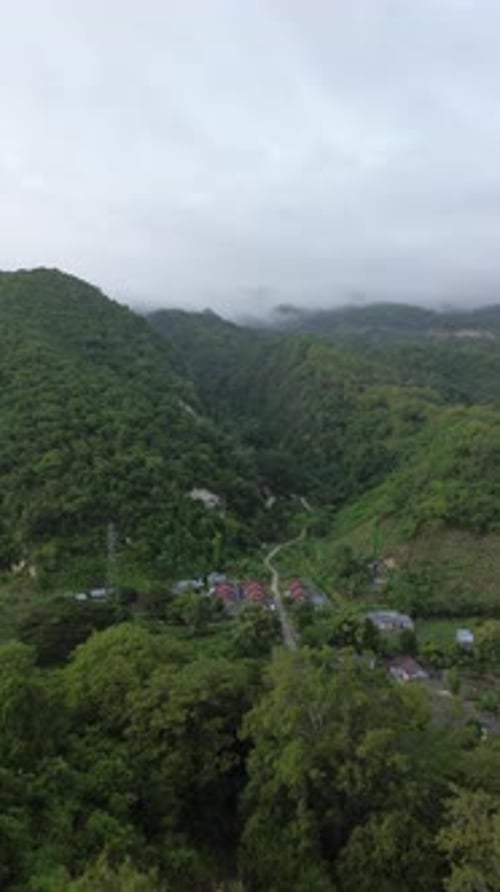 Vertical aerial footage of mountains and valley