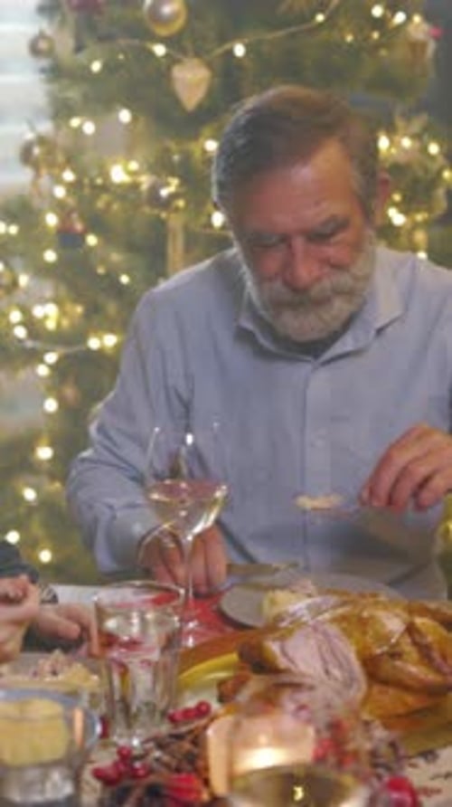 Peaceful Christmas Celebration Featuring Man Carving Turkey Amidst Festive Decorations and Gentle