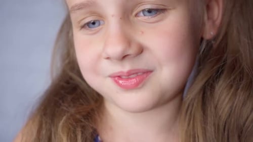 Smiling Girl with Blond Hair Close Up