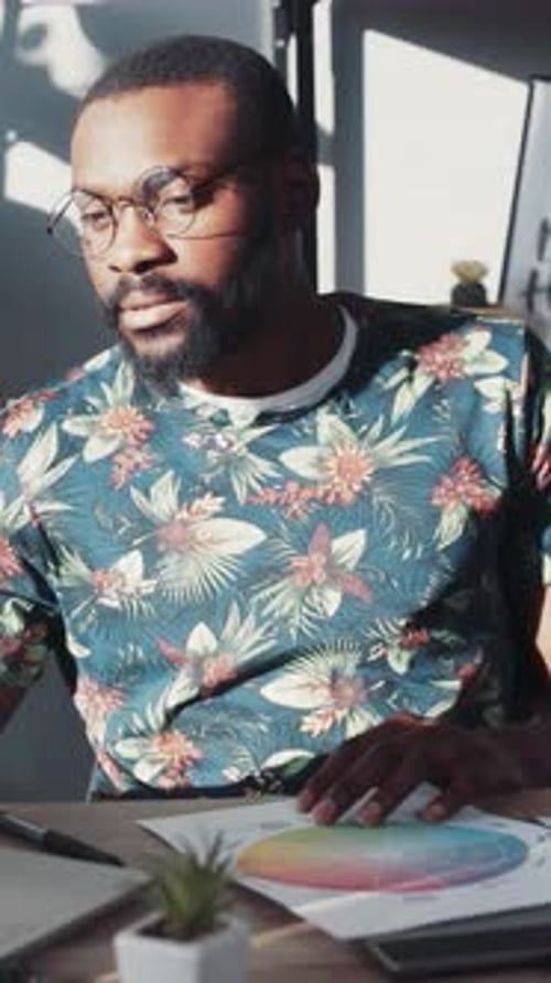 Creative Designer Working at Desk With Color Palette